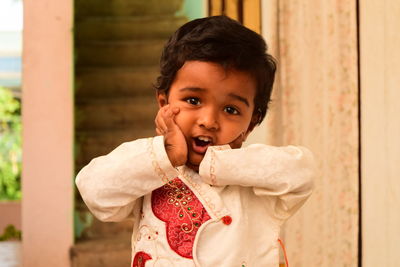 Portrait of cute baby boy standing outdoors