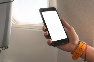 Midsection of person using mobile phone