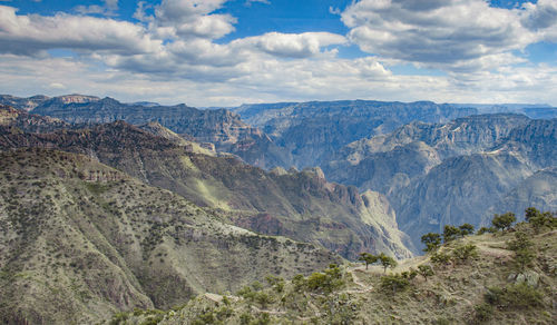 Scenic view of mountains against cloudy sky