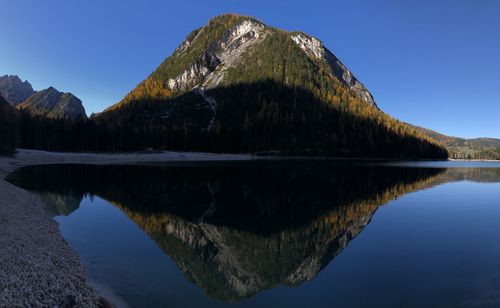 Scenic view of lake against clear blue sky