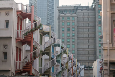 Beautiful architecture of colorful exterior spiral staircases of shophouse in bugis, singapore