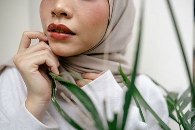 Close-up portrait of young woman holding hands