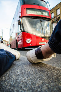 Low section of man skateboarding on street in city