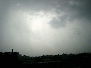 Scenic view of storm clouds over silhouette landscape