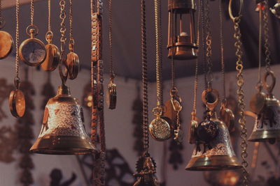 Bells with pocket watches hanging in market for sale