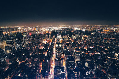 High angle view of illuminated city buildings at night