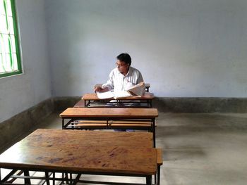 Young woman sitting on table
