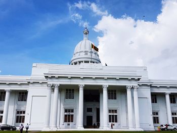 Low angle view of building against cloudy sky