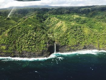 Scenic view of waterfall against sky