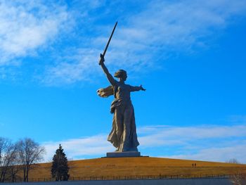 Low angle view of statue against blue sky