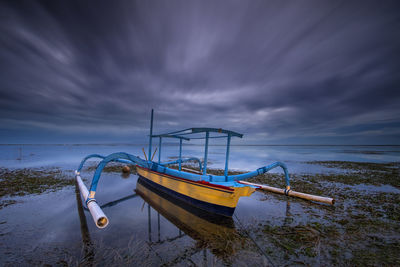 Ship moored on sea against sky