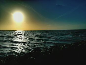 Scenic view of sea against sky at sunset