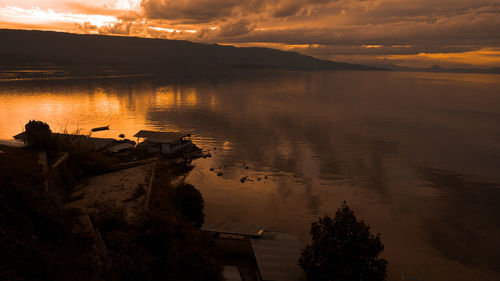 Scenic view of lake against sky during sunset