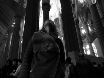 Low angle view of woman standing in corridor