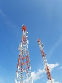 Low angle view of communications tower against blue sky