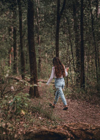 Full length of a man walking in forest