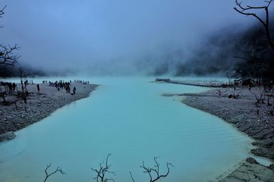 Panoramic view of crowd on shore against sky