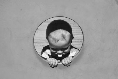 Close-up of baby boy with pacifier in mouth at play equipment