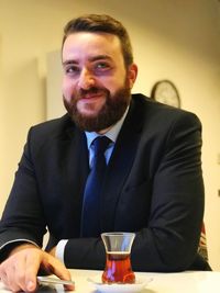 Portrait of mid adult man sitting at restaurant