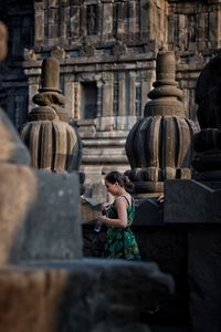 Full length of senior man outside temple against building