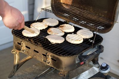 High angle view of person preparing food on barbecue