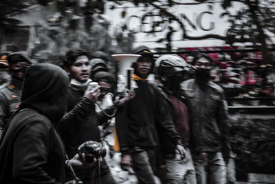 Group of people walking on street in city