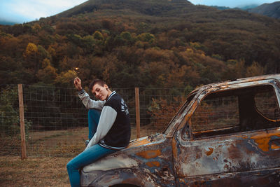 Full length of man sitting in car