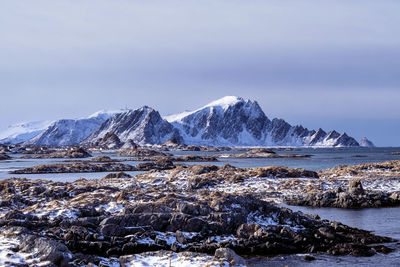 Beautiful rocky coastal landscape at andenes in vesteralen, norway, with snowcapped mountains