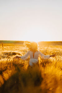 Woman on field against clear sky