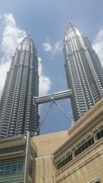 Low angle view of modern buildings against sky in city