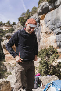 Portrait of cheerful man climber getting ready before climbing