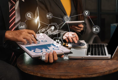 Midsection of businessman working at table