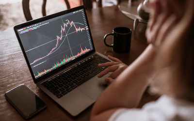 Young woman looking at the market on laptop