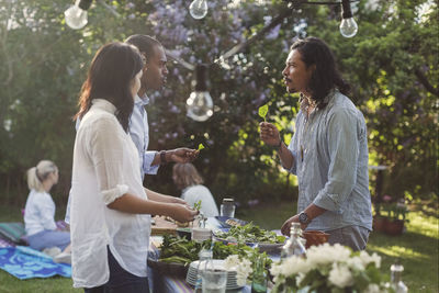 Rear view of women standing on table