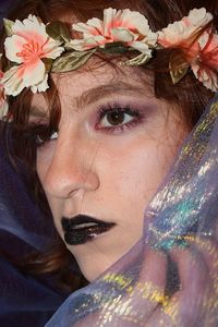 Close-up of young woman wearing flowers