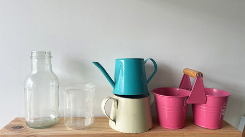 Close-up of bottles on table against wall