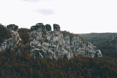 Panoramic view of rocks and trees against sky