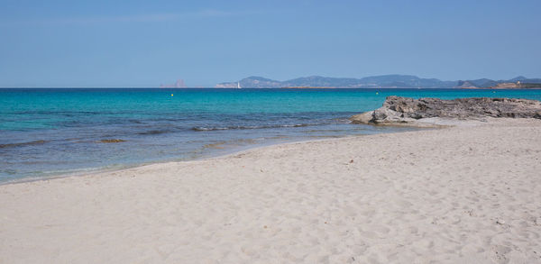 Scenic view of beach against clear sky