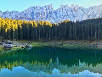 Scenic view of lake by snowcapped mountains during winter