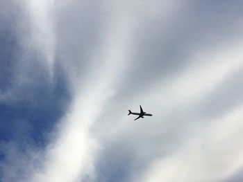 Low angle view of airplane flying in sky