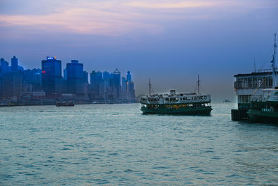 View of sea and buildings against sky during sunset