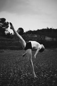 Full length of woman dancing on land against sky