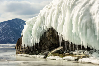 View of beautiful drawings on ice from cracks on the surface of lake teletskoye in winter, russia