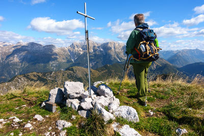 Rear view of man looking at mountain against sky