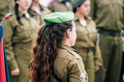 Rear view of woman looking at camera