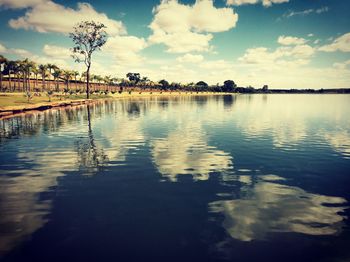 Scenic view of lake against cloudy sky