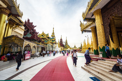 People walking outside the shwedagon pagoda