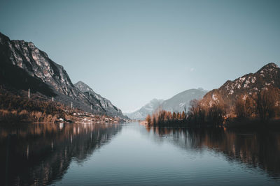 Scenic view of lake and mountains against clear sky