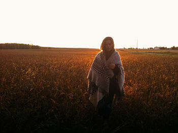 Woman standing on a wheat field