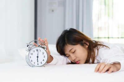 Woman sleeping on bed at home